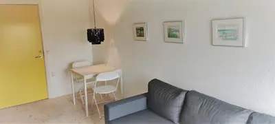 a living room with a couch and a table at Feriehus Thy - I hjertet af Thy in Thisted