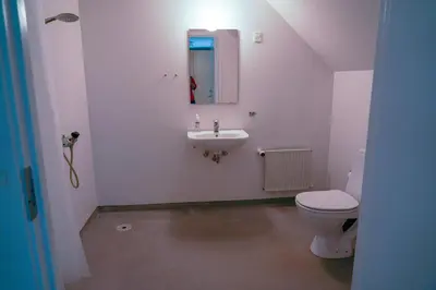 a small bathroom with a toilet and a sink at Feriehus Thy - I hjertet af Thy in Thisted
