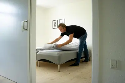 a man standing on a bed in a room at Feriehus Thy - I hjertet af Thy in Thisted