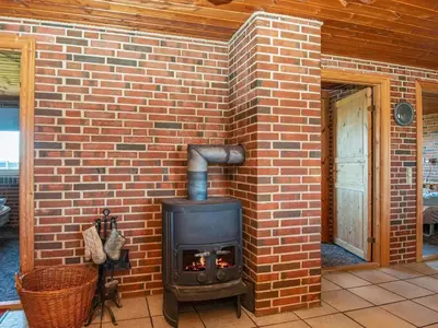 a brick wall with a stove in a patio at 14 person holiday home in Harboøre in Harboør