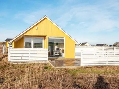 a yellow and white house on the beach at 5 person holiday home in Lemvig in Lemvig