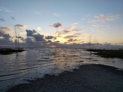 a large body of water with a sunset in the background at 6 person holiday home in Thisted-By Traum in Thisted