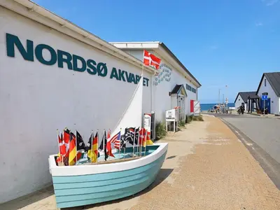 a boat on the side of a building with flags on it at Holiday Home with Terrace & Fire Pit in Thisted