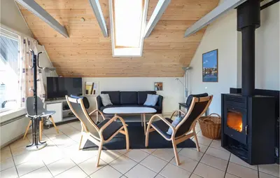 a living room with a couch and a stove at 3 Bedroom Awesome Home In Thisted in Thisted