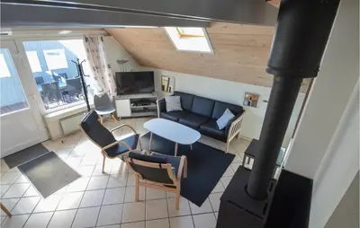 a living room with a couch and a table and chairs at 3 Bedroom Awesome Home In Thisted in Thisted