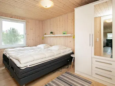 a bedroom with a large bed in a room at Cozy Coastal Retreat in Vorupor-By Traum in Thisted