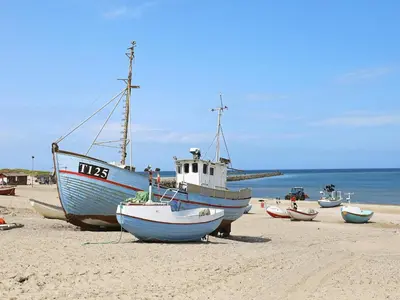 a group of boats sitting on the beach at Cozy Coastal Retreat in Vorupor-By Traum in Thisted
