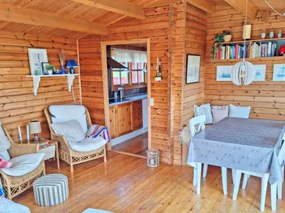 a dining room with a table and chairs in a cabin at 6 person holiday home in Lemvig in Lemvig