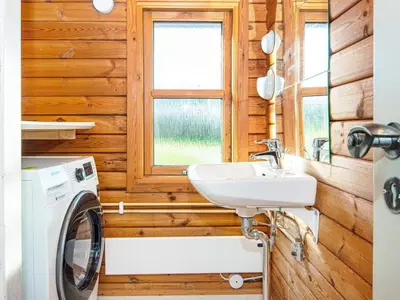 a bathroom with a washing machine and a sink at 6 person holiday home in Lemvig in Lemvig