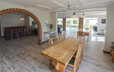 a large room with a wooden table and chairs at Lovely Home In Fur With Kitchen in Fur