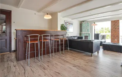 a living room with a bar with stools at Lovely Home In Fur With Kitchen in Fur