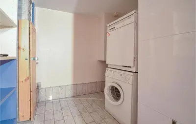 a laundry room with a washing machine and a washer at Lovely Home In Fur With Kitchen in Fur