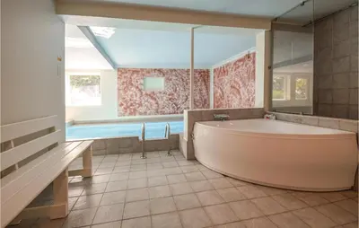 a large bathroom with a tub and a swimming pool at Lovely Home In Fur With Kitchen in Fur