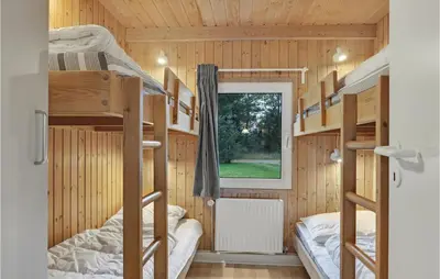 a bedroom with bunk beds in a tiny house at 4 Bedroom Beautiful Home In Saltum in Saltum