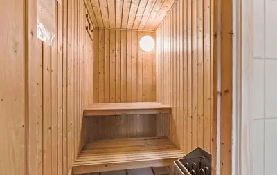 a wooden sauna with a small window in it at 4 Bedroom Beautiful Home In Saltum in Saltum