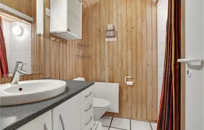 a bathroom with a sink and a toilet at 4 Bedroom Beautiful Home In Saltum in Saltum