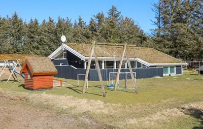 a playground in front of a house with a swing at 4 Bedroom Beautiful Home In Saltum in Saltum