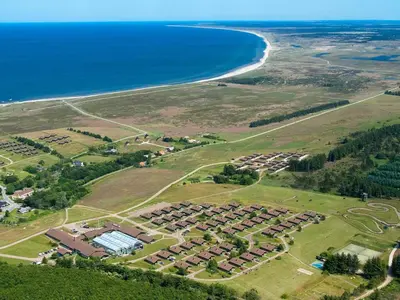 an aerial view of a resort next to the ocean at Vegsø Holiday Park Premium Retreat in Hanstholm