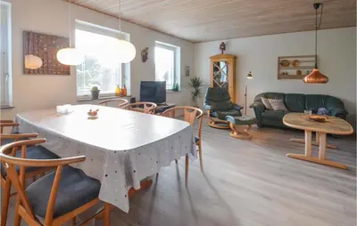 a living room with a table and a couch at 3 Bedroom Cozy Home In Fur in Fur