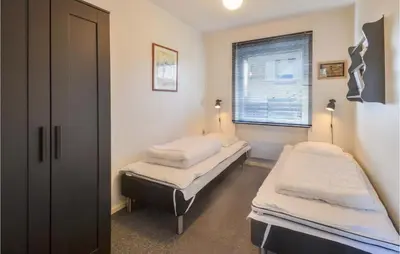 two twin beds in a room with a window at 3 Bedroom Cozy Home In Fur in Fur