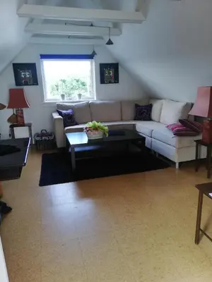 a living room with a couch and a table at Hunetorpvej Holiday Apartment in Blokhus
