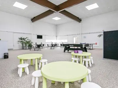 a classroom with tables and chairs and a chalkboard at 6 person holiday home in Brovst in Brovst