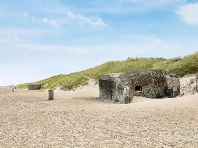 a stone building sitting on a sandy beach at 6 person holiday home in Brovst in Brovst