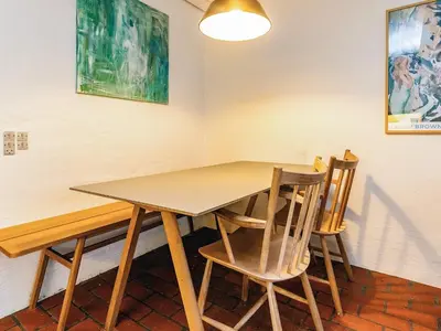 a wooden table and chairs in a room at 6 person holiday home in Brovst in Brovst