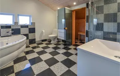 a bathroom with a tub and a toilet and a sink at Lovely Home In Vinderup With Wifi in Vinderup