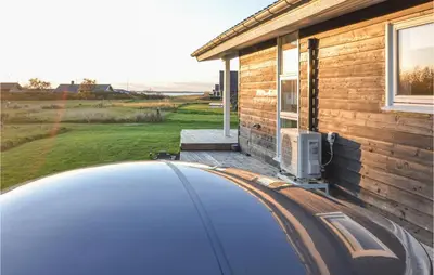 a car is parked outside of a house at Lovely Home In Vinderup With Wifi in Vinderup