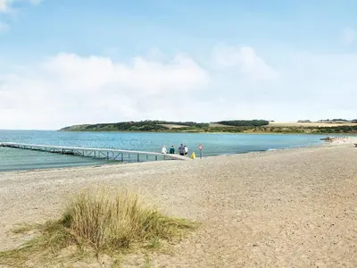 a group of people standing on a pier near the water at 5 person holiday home on a holiday park in Lemvig in Lemvig