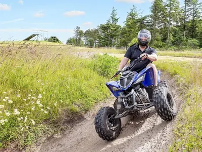a man riding a dirt bike down a dirt road at Modern comfort holiday home in Hanstholm