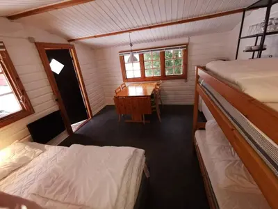 a room with a desk and a bed and a table at Glyngøre Camping in Glyngøre