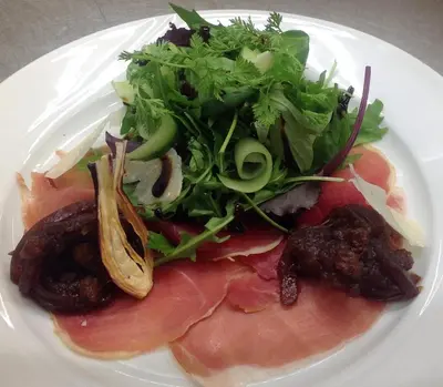 a plate of food with meat and a salad at Aars Hotel in Års