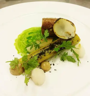 a white plate of food with vegetables and sauce at Aars Hotel in Års