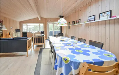 a dining room with a long table and chairs at Amazing Home In Thisted With Kitchen in Thisted