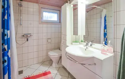 a bathroom with a sink and a toilet and a mirror at Amazing Home In Thisted With Kitchen in Thisted