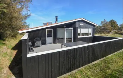 a black tiny house with a black fence at Amazing Home In Thisted With Kitchen in Thisted