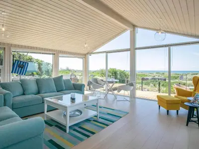 a living room with a couch and a table at 6 person holiday home in Løkken in Løkken