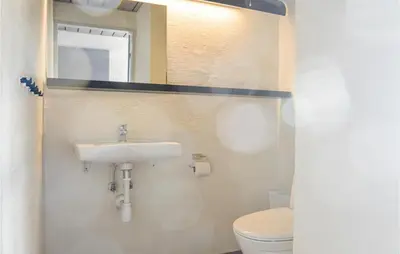 a bathroom with a sink and a toilet at Feriehotel Tranum Klit in Brovst