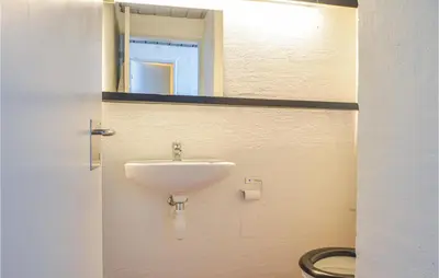 a bathroom with a sink and a toilet at Feriehotal Tranum Klit in Brovst