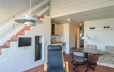 a living room with a kitchen and a dining room at Feriehotel Tranum Klit in Brovst