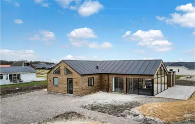 a house with a metal roof on top of a driveway at Nice Home In Harboøre With Sauna in Harboør