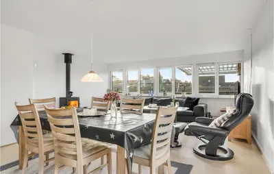 a dining room and living room with a table and chairs at 2 Bedroom Lovely Home In Thisted in Thisted