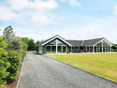 an external view of a house with a driveway at 15 person holiday home in Højslev in Højslev