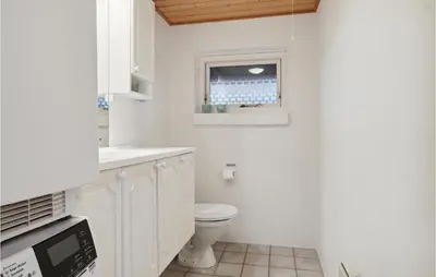 a white bathroom with a toilet and a window at Gorgeous Home In Thisted With Sauna in Thisted