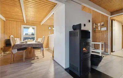 a kitchen and dining room with a stove in a room at Gorgeous Home In Thisted With Sauna in Thisted
