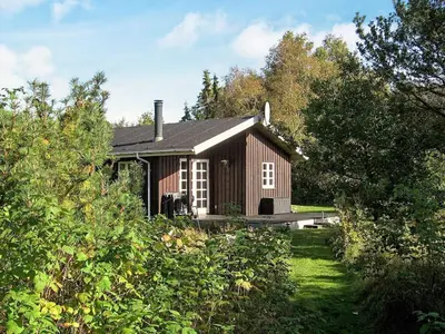 a small house in the middle of a field at Secluded Forest Retreat at Gjol-By Traum in Åbybro