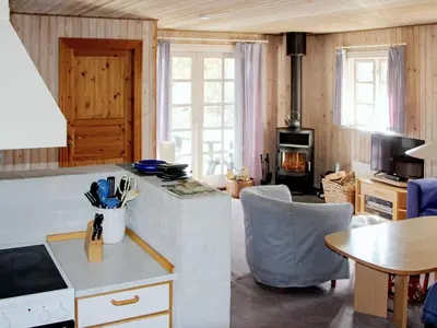 a kitchen and dining room with a table and a tableablish at Secluded Forest Retreat at Gjol-By Traum in Åbybro