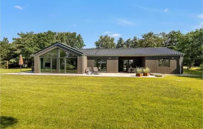 a house with a large yard with a green lawn at 4 Bedroom Cozy Home In Spøttrup in Spottrup